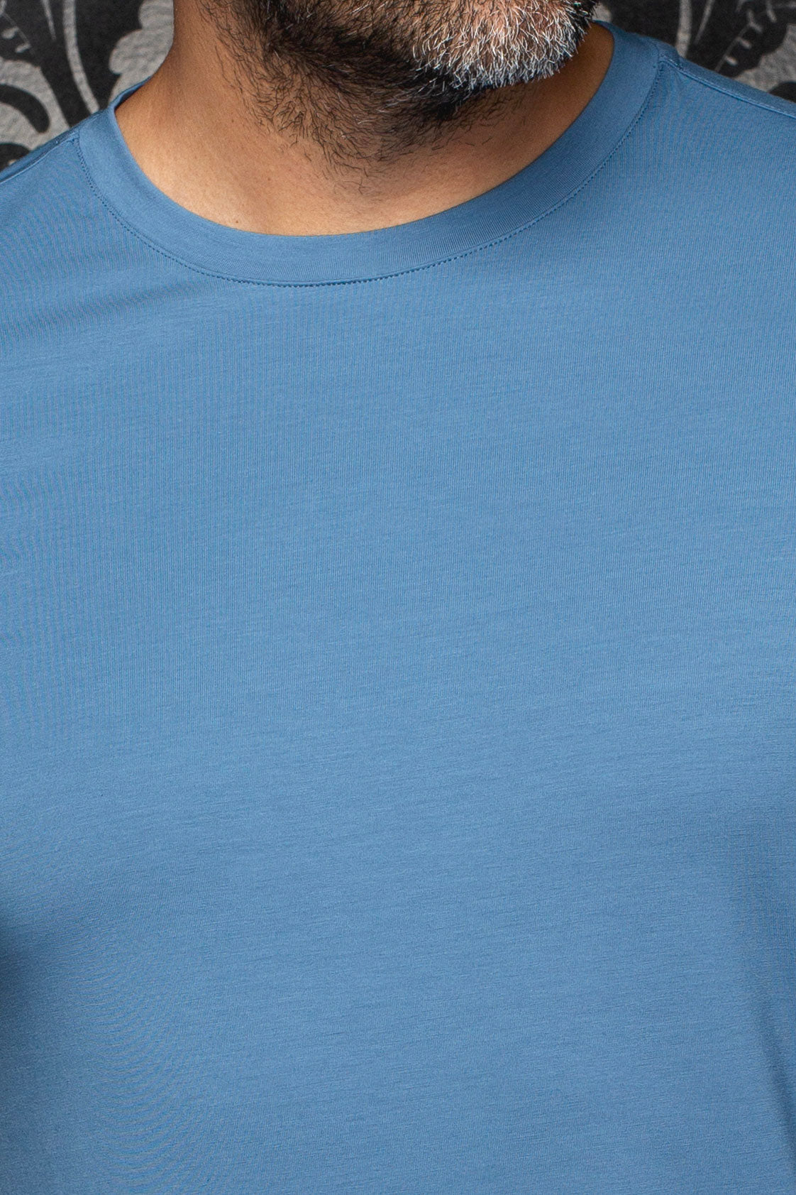T-Shirt bleu montrant le col rond côtelé et la texture jersey fine pour homme par Au Noir, en gros plan