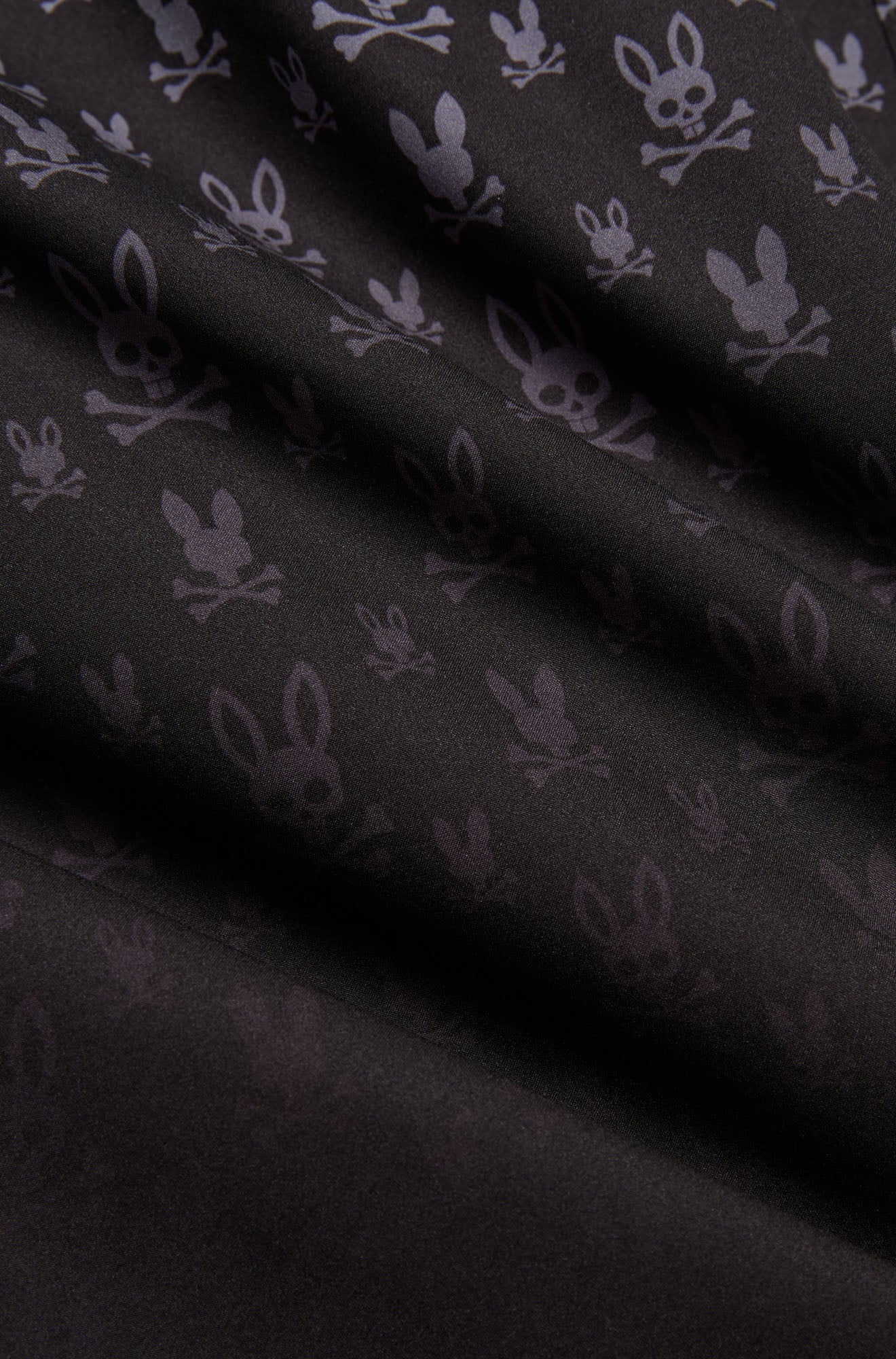 Psycho Bunny men's black swim shorts, detail view