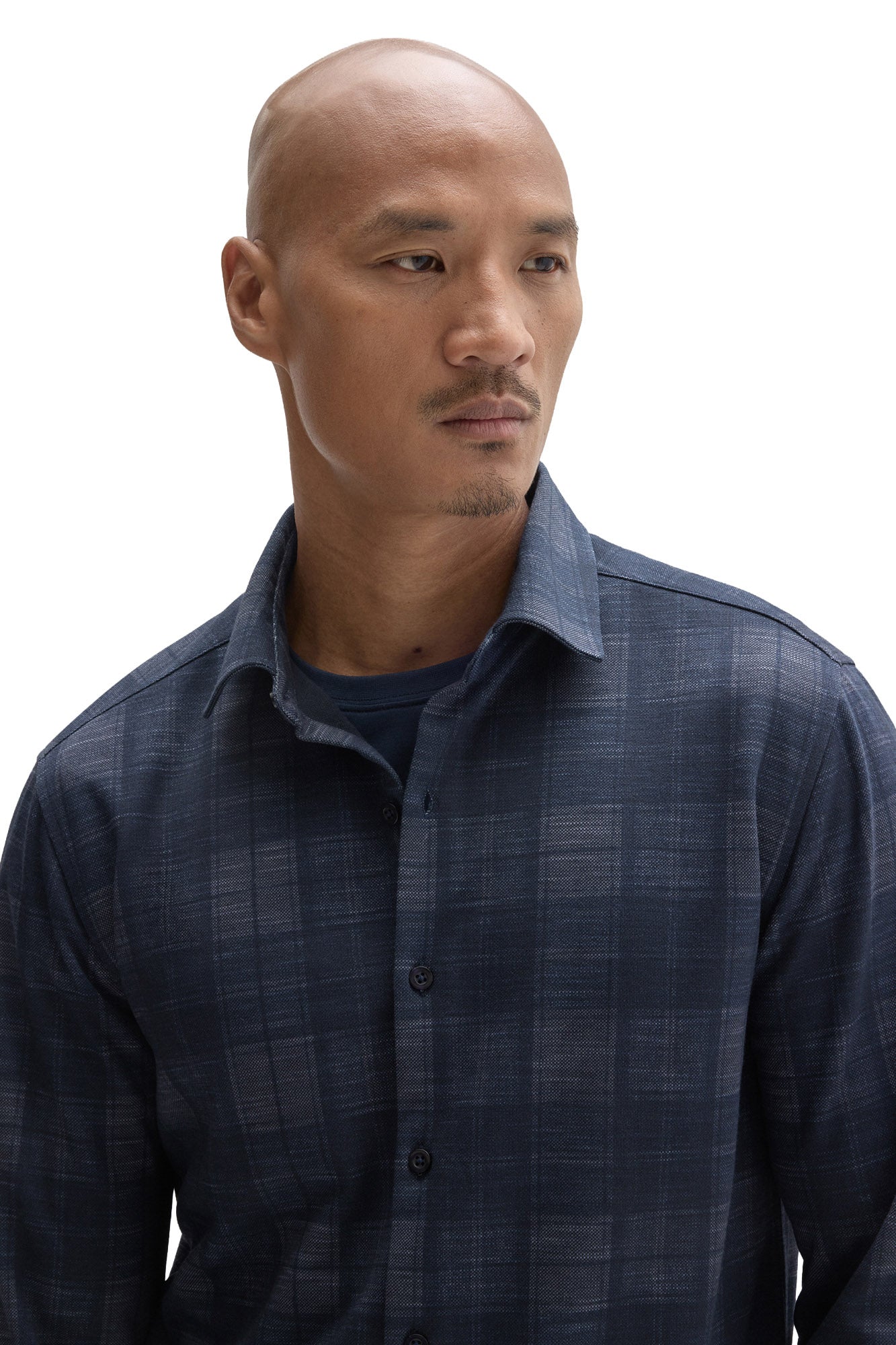 Close-up of textured fabric, front buttons and spread collar on Robert Barakett men's navy plaid overshirt