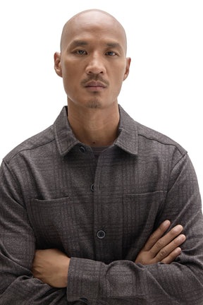 Robert Barakett men's close detail of charcoal plaid overshirt with dark buttons, chest pockets and point collar